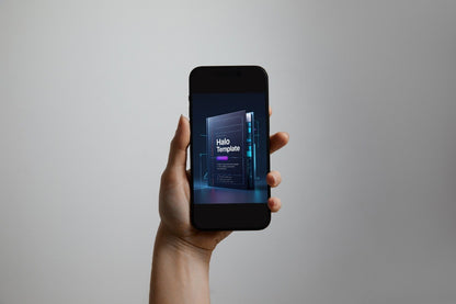 A hand holding a black smartphone against a plain light gray background. The phone screen displays a dark futuristic template mockup with the text 'Halo Template'.
